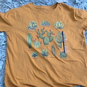 I am selling a yellow/orange short sleeve women’s shirt! I have not worn it!